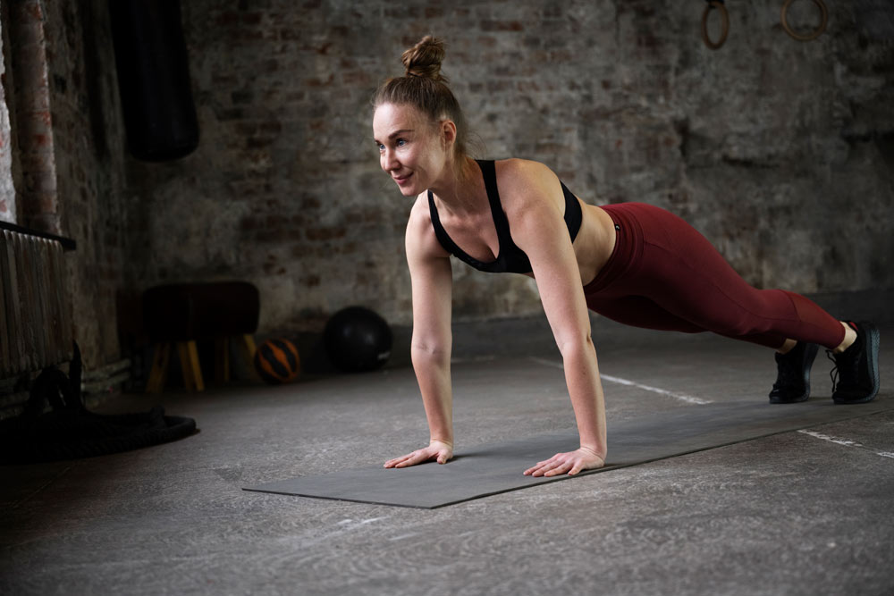 full-shot-woman-training-yoga-mat