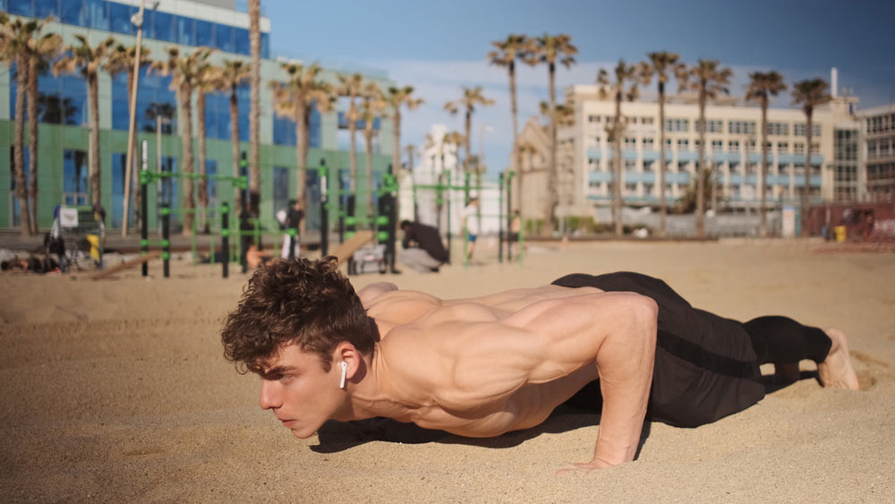 young-attractive-muscular-man-pushingup-during-functional-training-beach-fit-guy-workout-outdoor